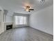 Bright living room featuring hardwood floors, a fireplace, and large windows at 7163 S Durango Dr # 302, Las Vegas, NV 89113