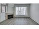 Cozy living room with a fireplace, window with blinds, and stylish flooring at 7163 S Durango Dr # 302, Las Vegas, NV 89113