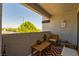 Cozy covered balcony with patio furniture, textured walls, and an outdoor view at 7255 W Sunset Rd # 2030, Las Vegas, NV 89113