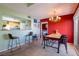 An open dining area with a bar and chandelier creates a seamless entertaining space at 7255 W Sunset Rd # 2030, Las Vegas, NV 89113