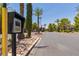 Community entrance with a security gate, palm trees and landscaped grounds at 7255 W Sunset Rd # 2030, Las Vegas, NV 89113