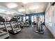 Community gym with treadmills, weights, and exercise machines with mirrored wall at 7255 W Sunset Rd # 2030, Las Vegas, NV 89113