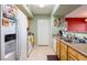 Efficient kitchen features laminate countertops, essential appliances, and connects to the dining area at 7255 W Sunset Rd # 2030, Las Vegas, NV 89113