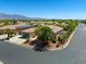 Tile roof home on corner lot with mature palm trees in desert landscape neighborhood, mountain backdrop at 7286 Mount Kearsarge St, Las Vegas, NV 89131