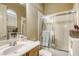 Well-organized bathroom featuring a vanity with storage and a shower-tub combo with glass doors at 7286 Mount Kearsarge St, Las Vegas, NV 89131