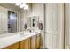 Well-lit bathroom featuring a large mirror, single sink vanity, and a shower-tub combination at 7286 Mount Kearsarge St, Las Vegas, NV 89131