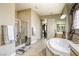 Bright primary bathroom with soaking tub and glass shower enclosure at 7286 Mount Kearsarge St, Las Vegas, NV 89131