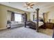 Bedroom featuring a four-poster bed, sitting area and ceiling fan at 7286 Mount Kearsarge St, Las Vegas, NV 89131