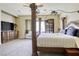 Primary bedroom showcases a four-poster bed and carpet flooring at 7286 Mount Kearsarge St, Las Vegas, NV 89131