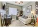 Functional bedroom with a desk, and sofa, offering versatility for work and relaxation at 7286 Mount Kearsarge St, Las Vegas, NV 89131