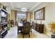 Elegant dining room featuring a dark wood table, cushioned chairs, and decorative accents at 7286 Mount Kearsarge St, Las Vegas, NV 89131