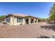 Single-story home with a covered patio and low-maintenance rock landscaping in the backyard at 7286 Mount Kearsarge St, Las Vegas, NV 89131