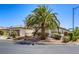 Landscaped front view of single-story home featuring desert landscaping, tile roof, and two-car garage at 7286 Mount Kearsarge St, Las Vegas, NV 89131