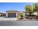 Charming single-story home featuring a tile roof, desert landscaping, and an attached two-car garage at 7286 Mount Kearsarge St, Las Vegas, NV 89131