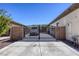 Gated driveway to a single-story home featuring an ornate metal gate, block walls, and a paved driveway at 7286 Mount Kearsarge St, Las Vegas, NV 89131
