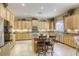 Well-equipped kitchen with stainless appliances, island, and breakfast bar at 7286 Mount Kearsarge St, Las Vegas, NV 89131
