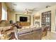 Inviting living room featuring tile floors, leather furniture, and a fireplace at 7286 Mount Kearsarge St, Las Vegas, NV 89131