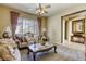 Living room features a carpet, traditional furniture, natural light, curtains, and ceiling fan at 7286 Mount Kearsarge St, Las Vegas, NV 89131