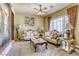 Comfortable living room with carpet, decorative furniture, curtains, and ceiling fan with lights at 7286 Mount Kearsarge St, Las Vegas, NV 89131