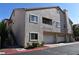 Multi-level condo building with garage parking and second-story entrances and neutral stucco finish at 7450 S Eastern Ave # 1012, Las Vegas, NV 89123
