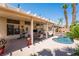 Relaxing backyard oasis with a covered patio, dining area, and a sparkling pool with rock features at 7540 Flowing Stream Dr, Las Vegas, NV 89131