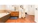 Bathroom featuring a soaking tub with tile surround, wood vanity, and tile flooring at 7540 Flowing Stream Dr, Las Vegas, NV 89131