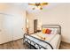 Charming bedroom features a ceiling fan, closet and a comfortable bed with stylish accents at 7540 Flowing Stream Dr, Las Vegas, NV 89131