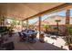 Inviting covered patio with a dining table and view of the pool in a well-maintained backyard at 7540 Flowing Stream Dr, Las Vegas, NV 89131
