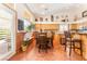 Eat-in kitchen with a dining table set for six, warm wood cabinetry and plenty of natural light at 7540 Flowing Stream Dr, Las Vegas, NV 89131
