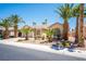 Attractive home exterior with desert landscaping including palm trees, and a two-car garage at 7540 Flowing Stream Dr, Las Vegas, NV 89131