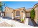 Inviting home exterior featuring a well-manicured lawn, desert landscaping, and a two-car garage at 7540 Flowing Stream Dr, Las Vegas, NV 89131
