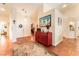 Spacious foyer with tile flooring, decorative rug, and stylish red storage cabinet at 7540 Flowing Stream Dr, Las Vegas, NV 89131