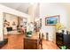 Versatile office space with a vintage wooden desk, connecting to the kitchen and living areas for seamless living at 7540 Flowing Stream Dr, Las Vegas, NV 89131