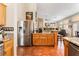 Spacious kitchen features stainless steel refrigerator and granite countertops, connecting to the living area for easy entertaining at 7540 Flowing Stream Dr, Las Vegas, NV 89131