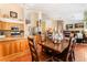 The spacious kitchen features stainless steel appliances and flows into a dining area with a large wooden table at 7540 Flowing Stream Dr, Las Vegas, NV 89131