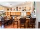 Open kitchen boasts granite countertops, mosaic backsplash, and warm wood cabinetry, perfect for culinary enthusiasts at 7540 Flowing Stream Dr, Las Vegas, NV 89131
