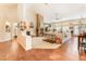 Bright, open-concept living room with a stone fireplace, plush seating, and large windows at 7540 Flowing Stream Dr, Las Vegas, NV 89131