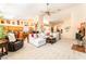 Open-concept living area with tile floors, a plush white sofa, and views into the kitchen at 7540 Flowing Stream Dr, Las Vegas, NV 89131