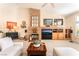 Comfortable living room featuring a stone fireplace, built-in shelves, and modern decor at 7540 Flowing Stream Dr, Las Vegas, NV 89131