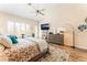 Comfortable main bedroom featuring a ceiling fan, a mounted TV, and a dresser with decor at 7540 Flowing Stream Dr, Las Vegas, NV 89131