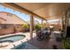 Covered patio offers a dining area and a view of the pool, creating an ideal space for outdoor entertaining at 7540 Flowing Stream Dr, Las Vegas, NV 89131