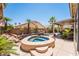 Backyard pool and spa with a rock water feature, surrounded by lush tropical landscaping at 7540 Flowing Stream Dr, Las Vegas, NV 89131