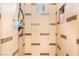 Walk-in shower featuring tile surround, shower head and built-in toiletry storage at 7540 Flowing Stream Dr, Las Vegas, NV 89131