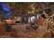 Evening backyard view featuring flagstone patio, string lights, and a dining set, creating a cozy outdoor space at 7728 Whispering River St, Las Vegas, NV 89131