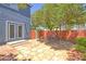 Charming backyard with flagstone patio, mature trees, and a quaint outdoor dining set, creating a cozy retreat at 7728 Whispering River St, Las Vegas, NV 89131