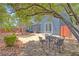 Serene backyard featuring a flagstone patio, mature trees, and an inviting outdoor dining area, perfect for relaxation at 7728 Whispering River St, Las Vegas, NV 89131