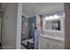 Charming bathroom featuring a blue tiled shower and vanity with a marble countertop at 7728 Whispering River St, Las Vegas, NV 89131