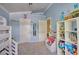 Bright bedroom with built-in bookshelves, a toy storage unit, and loft bed is perfect for  at 7728 Whispering River St, Las Vegas, NV 89131