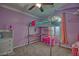 Bedroom featuring a loft bed with a built-in desk, complemented by a dresser and pink accents at 7728 Whispering River St, Las Vegas, NV 89131