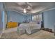 Bright primary bedroom boasts a ceiling fan, natural light, and a bed with integrated storage at 7728 Whispering River St, Las Vegas, NV 89131